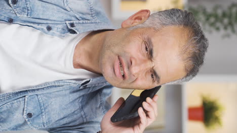 Vertical-video-of-Man-getting-bad-news-on-the-phone-gets-upset.